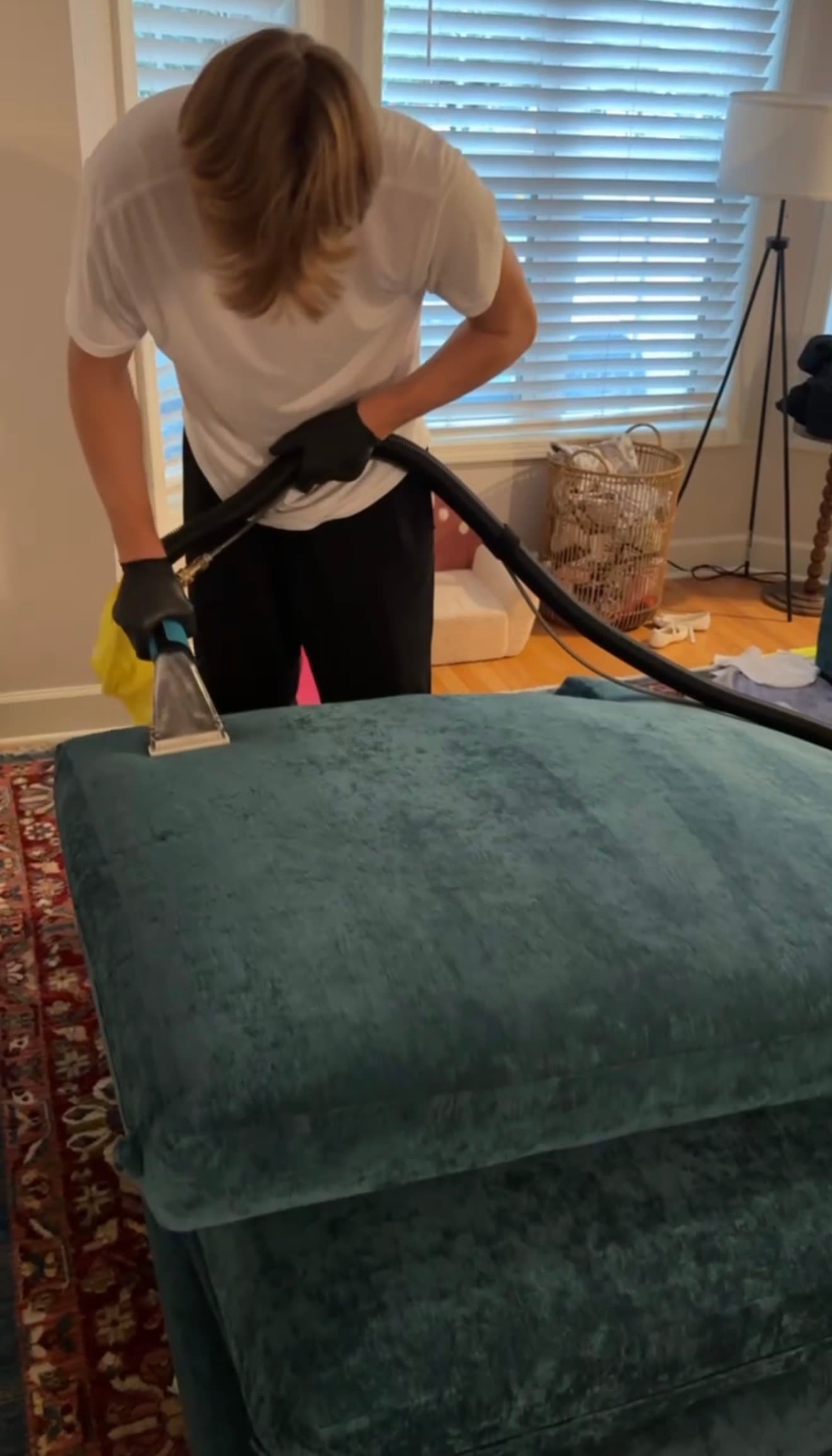 Orest performing upholstery extraction cleaning on a sofa cushion
