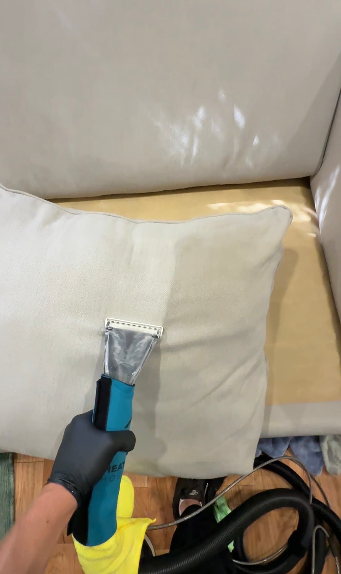 Hot water extraction cleaning being performed on a cushion